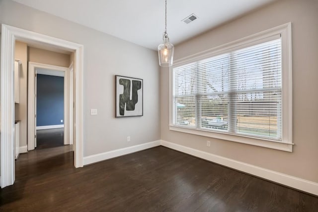 empty room with dark hardwood / wood-style floors