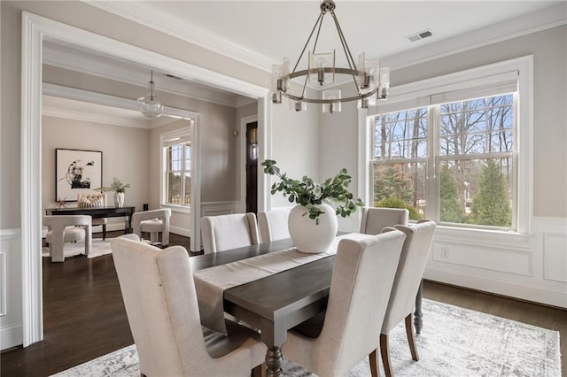 dining space featuring an inviting chandelier, crown molding, and a healthy amount of sunlight