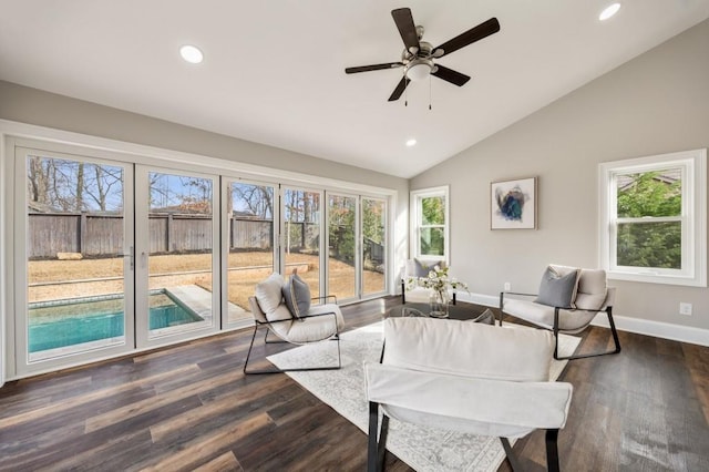 living room with vaulted ceiling, plenty of natural light, ceiling fan, and dark hardwood / wood-style flooring