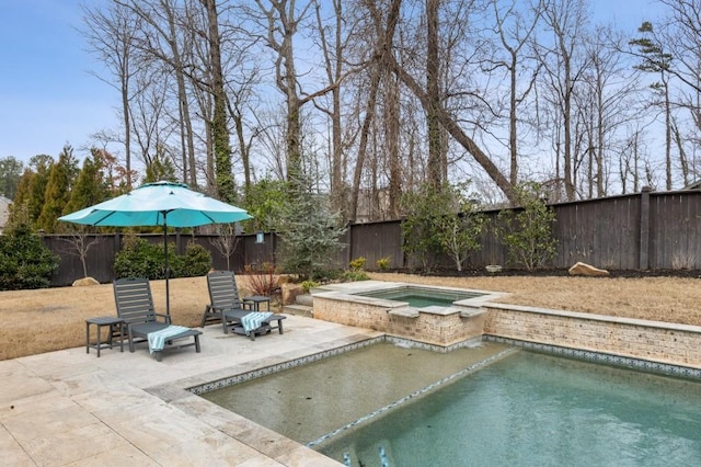 view of pool with an in ground hot tub and a patio