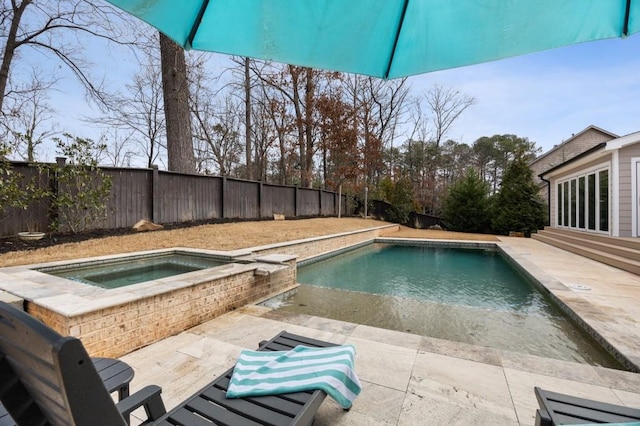 view of swimming pool featuring an in ground hot tub and a patio area