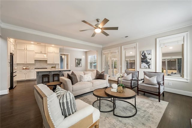 living room featuring dark hardwood / wood-style flooring, ornamental molding, and ceiling fan