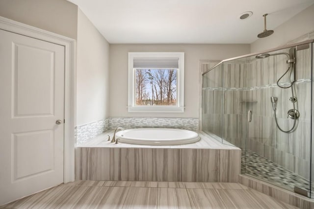 bathroom featuring separate shower and tub