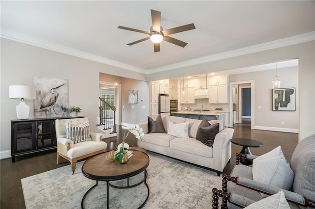 living room featuring crown molding, sink, ceiling fan, and dark hardwood / wood-style flooring