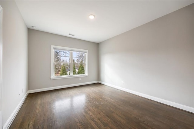 unfurnished room featuring dark wood-type flooring