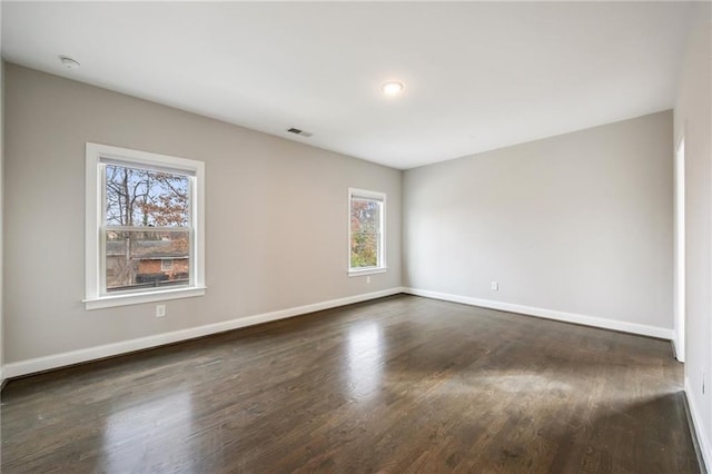 spare room with dark hardwood / wood-style flooring