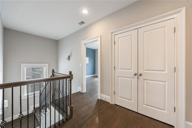 hallway with dark wood-type flooring