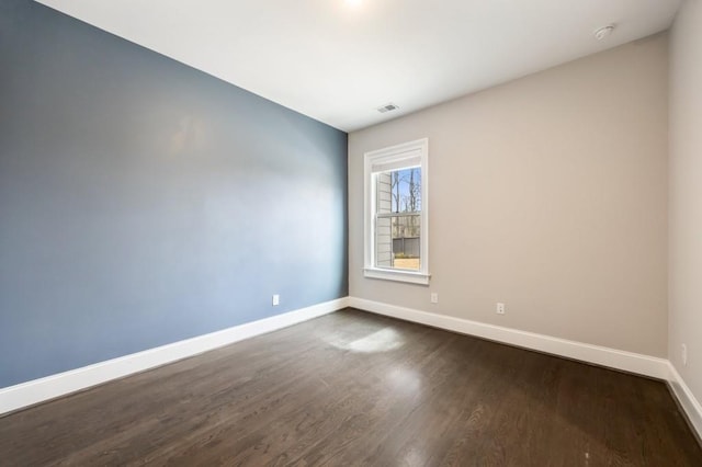 spare room with dark hardwood / wood-style flooring