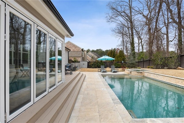 view of swimming pool with a patio area and an in ground hot tub