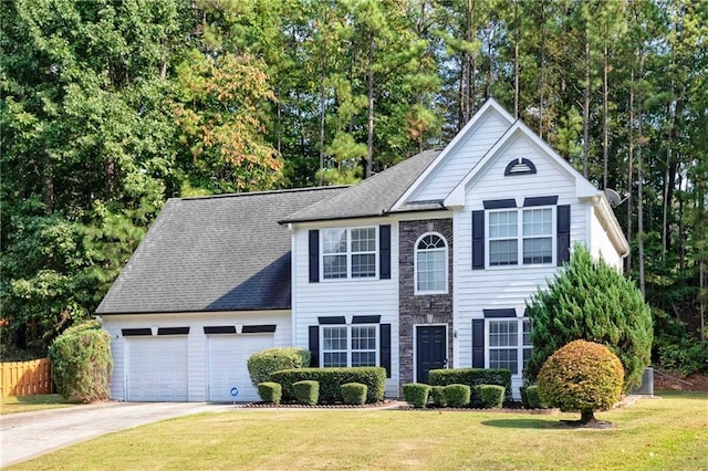 1731 Silverchase SW, Marietta, GA 30008 - view of front of home with a front yard, stone siding, concrete driveway, fence, and an attached garage
