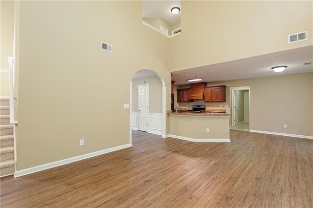 1731 Silverchase SW, Marietta, GA 30008 - unfurnished living room featuring light wood finished floors, baseboards, visible vents, and arched walkways