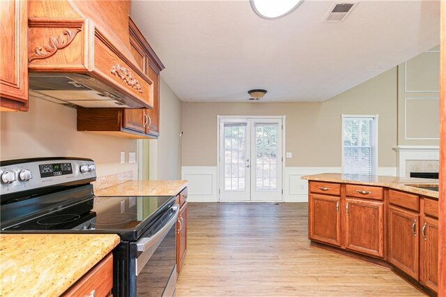 1731 Silverchase SW, Marietta, GA 30008 - kitchen featuring brown cabinets, a healthy amount of sunlight, stainless steel range with electric cooktop, and premium range hood