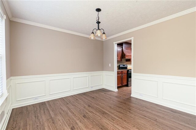 1731 Silverchase SW, Marietta, GA 30008 - unfurnished room with dark wood-style flooring, a textured ceiling, ornamental molding, an inviting chandelier, and wainscoting