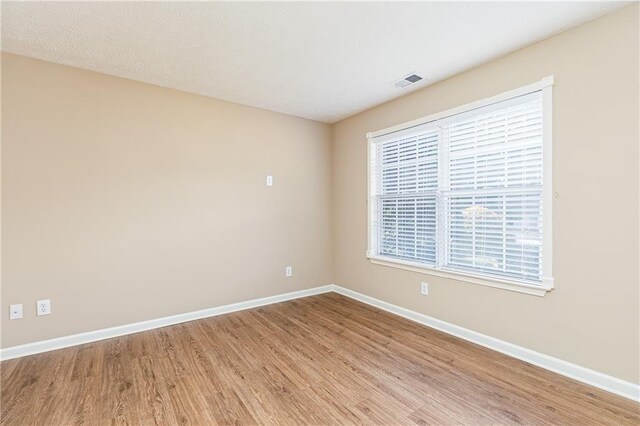 1731 Silverchase SW, Marietta, GA 30008 - empty room with baseboards, visible vents, and wood finished floors