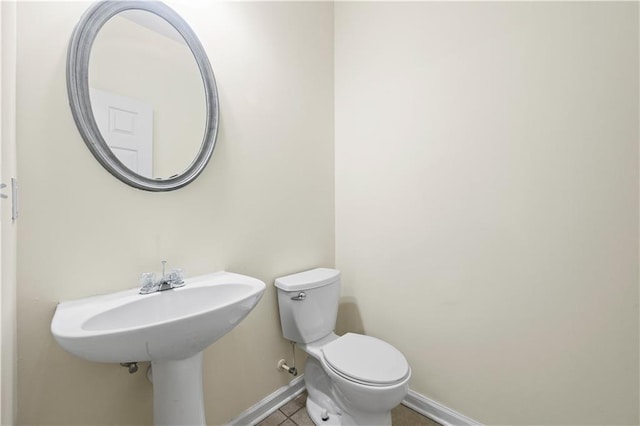 bathroom with tile patterned flooring and toilet