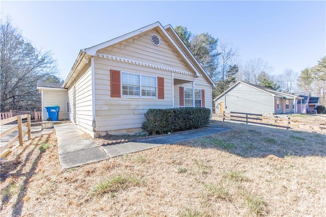 bungalow-style home with a front lawn