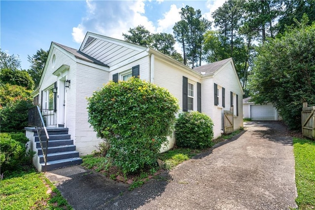 1359 Scott Blvd, Decatur, GA 30030 - view of front facade featuring brick siding, a detached garage, and an outbuilding