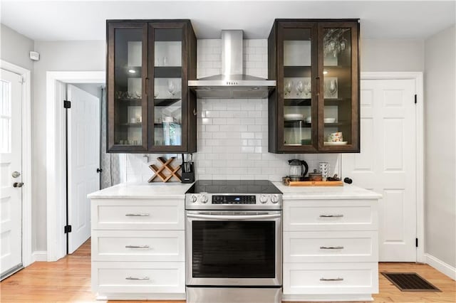 1359 Scott Blvd, Decatur, GA 30030 - kitchen with stainless steel electric range oven, wall chimney range hood, glass insert cabinets, and light wood-style flooring