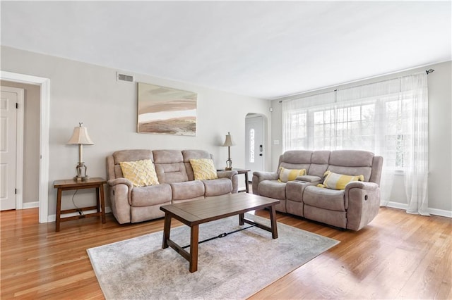 1359 Scott Blvd, Decatur, GA 30030 - living room featuring arched walkways, light wood-type flooring, and baseboards