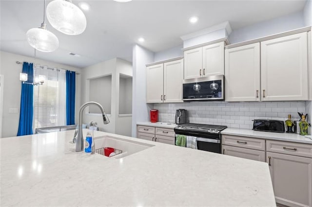 55 Clubhouse Way, Acworth, GA 30101 - kitchen with appliances with stainless steel finishes, a sink, light countertops, backsplash, and hanging light fixtures