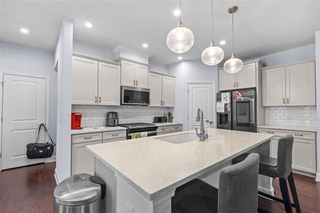 55 Clubhouse Way, Acworth, GA 30101 - kitchen with appliances with stainless steel finishes, a sink, a kitchen bar, light countertops, and decorative backsplash