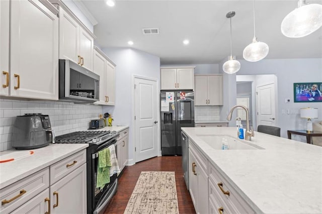 55 Clubhouse Way, Acworth, GA 30101 - kitchen with a sink, appliances with stainless steel finishes, dark wood-style floors, light countertops, and decorative backsplash