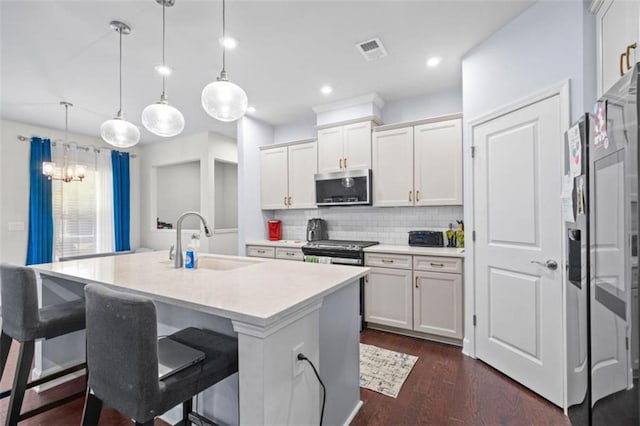 55 Clubhouse Way, Acworth, GA 30101 - kitchen featuring stainless steel appliances, a sink, light countertops, decorative backsplash, and a chandelier
