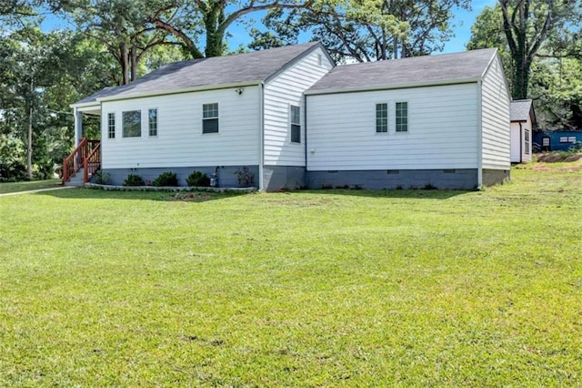 exterior space with crawl space and a front lawn