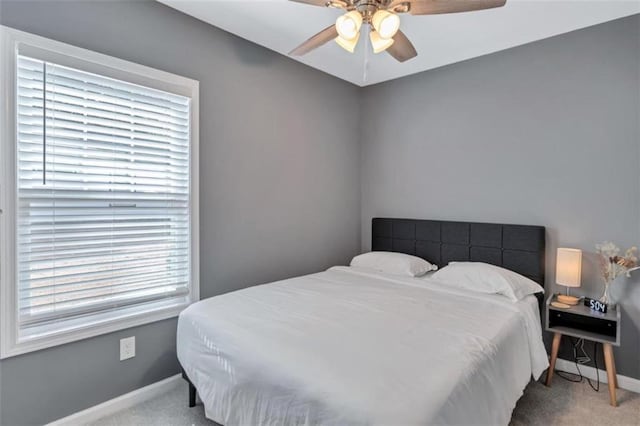 bedroom with ceiling fan and light carpet