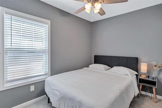 bedroom with baseboards, a ceiling fan, and carpet floors