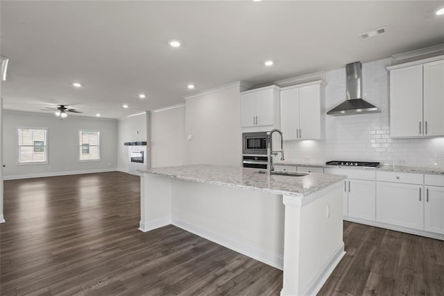 3382 Monarch Ave, Duluth, GA 30096 - kitchen featuring wall chimney exhaust hood, stainless steel appliances, a center island with sink, tasteful backsplash, and white cabinets