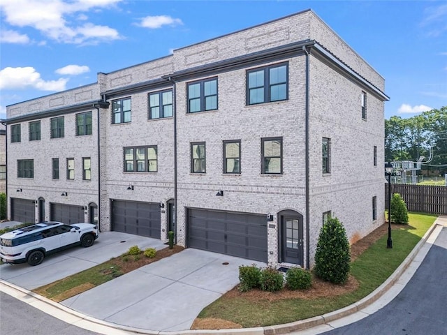 3382 Monarch Ave, Duluth, GA 30096 - view of front of home with a garage, driveway, and brick siding