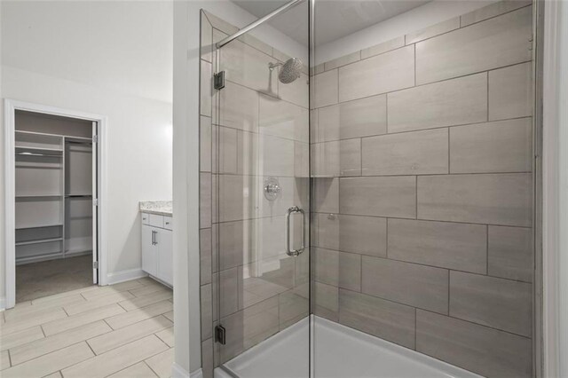 3382 Monarch Ave, Duluth, GA 30096 - full bath featuring a stall shower, a spacious closet, and vanity
