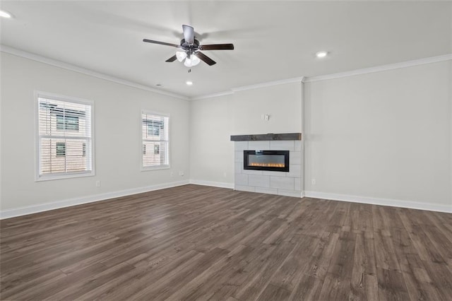 3382 Monarch Ave, Duluth, GA 30096 - unfurnished living room featuring crown molding, dark wood-style flooring, ceiling fan, recessed lighting, and a tile fireplace