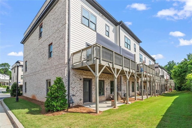 3382 Monarch Ave, Duluth, GA 30096 - back of house with a lawn, brick siding, a patio, and a deck