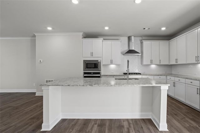 3382 Monarch Ave, Duluth, GA 30096 - kitchen with wall chimney exhaust hood, appliances with stainless steel finishes, a kitchen island with sink, tasteful backsplash, and crown molding