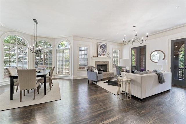 living room featuring ornamental molding, dark hardwood / wood-style flooring, and a chandelier