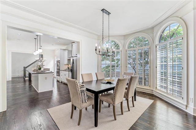 dining space with crown molding, dark wood-type flooring, and an inviting chandelier