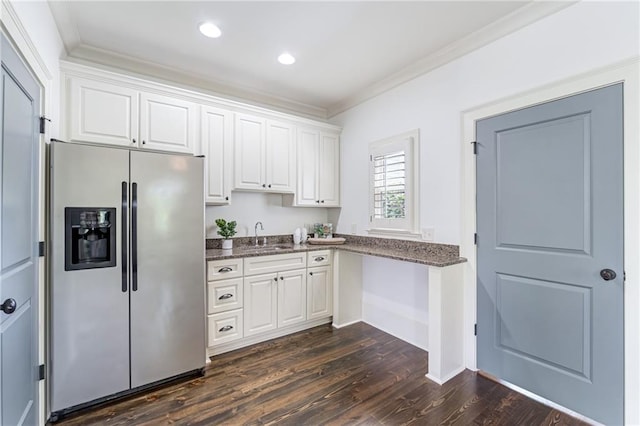 kitchen featuring dark wood-type flooring, stainless steel fridge with ice dispenser, and white cabinets