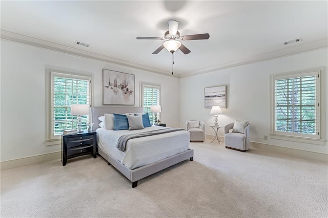 bedroom with ceiling fan, crown molding, and light colored carpet