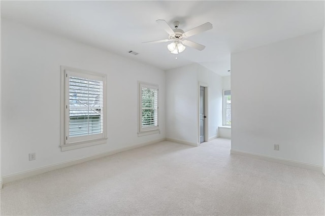 empty room with ceiling fan and light colored carpet