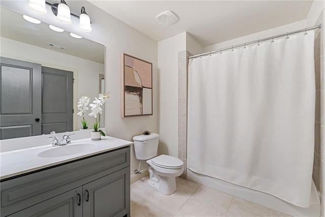 bathroom with toilet, a shower with shower curtain, vanity, and tile patterned floors