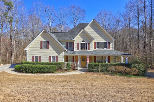 view of front of home featuring a porch and a front lawn