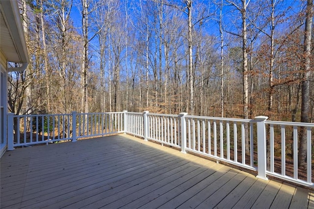 wooden terrace with a wooded view