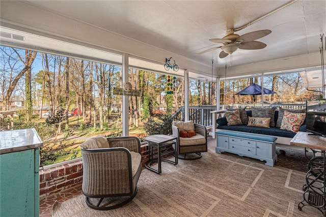 sunroom with plenty of natural light and ceiling fan