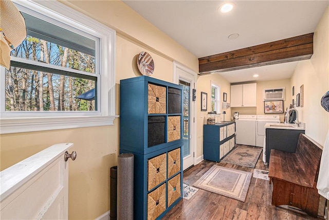 kitchen with baseboards, white cabinets, beam ceiling, dark wood-style floors, and washing machine and clothes dryer