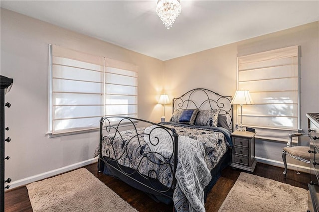 bedroom with dark wood-style flooring and baseboards