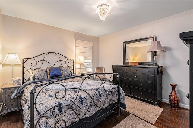 bedroom featuring baseboards and wood finished floors