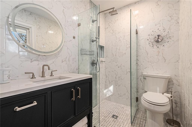 bathroom featuring tile walls, a shower stall, toilet, and vanity