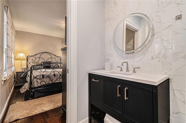 bathroom featuring wood finished floors, vanity, and baseboards